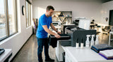Technician loading t-shirt onto DTG printer