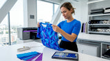 Fashion designer checking garment print quality