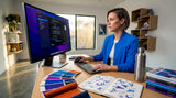 Designer adjusting print file settings at desk
