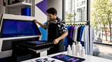 Entrepreneur operating DTG printer in workshop