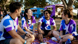 Group wearing matching custom festival t-shirts outdoors
