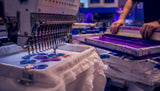 Close-up of silkscreen ink and embroidery stitching