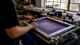 Hands adjusting halftone screen on press