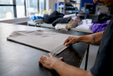 Hands measuring print placement on garment sleeve