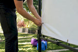 Hands adjusting step and repeat backdrop on frame
