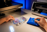 DTF and HTV transfer materials on studio bench