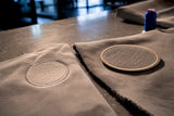 Cropped embroidered panel beside loose patch