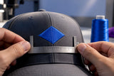Close-up measuring embroidered hat front placement