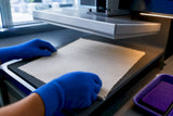Cotton test panel entering a heat press