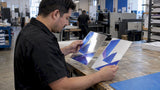 Foil and metallic ink samples tilted under shop light