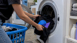Printed T-shirt being loaded into a washing machine