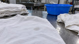 Water soaking into uncolored cotton fabric