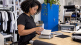 Designer weighing cotton jersey fabric samples