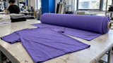 Violet shirt beside a roll of dyed fabric